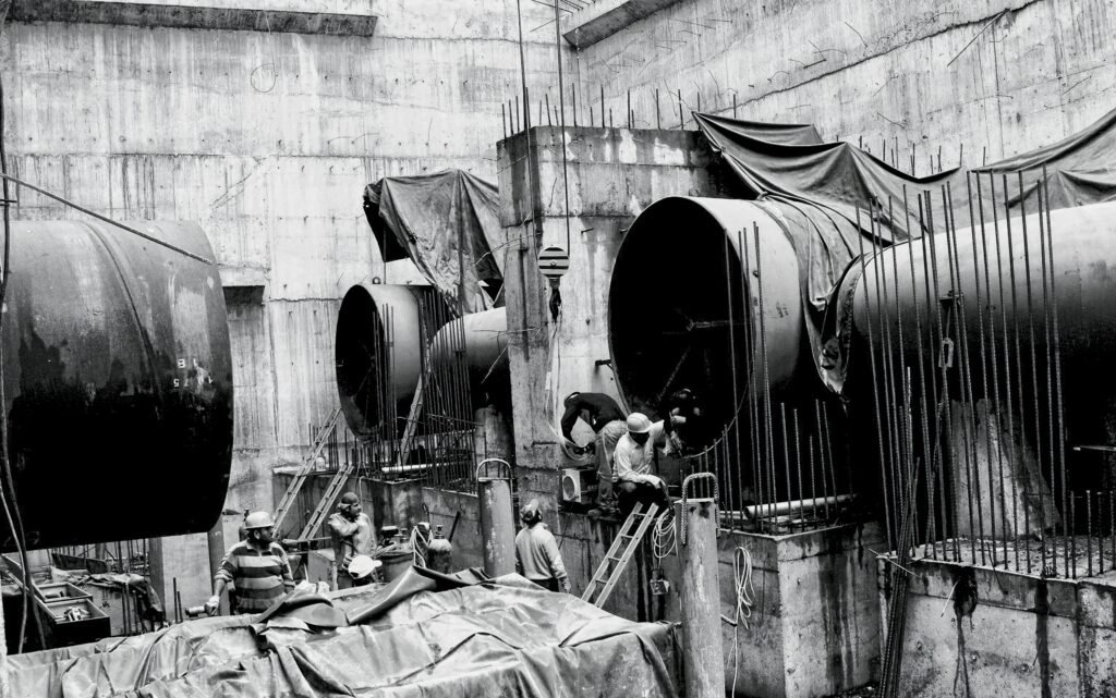 pexels photo 33040700 33040700 Construction workers at an industrial site in Adıyaman, Türkiye, working on large pipes.